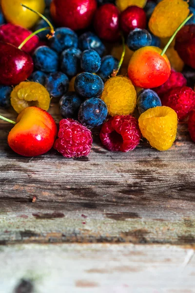 Mix of berries on wooden background — Stock Photo, Image