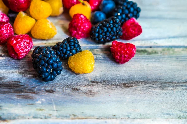 Mix of berries on wooden background — Stock Photo, Image