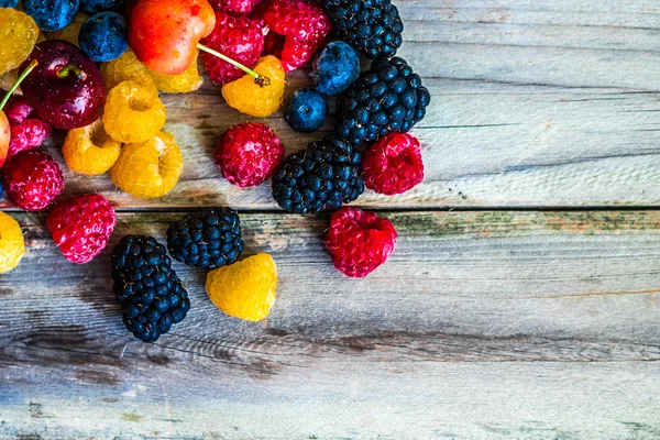 Mix of berries on wooden background — Stock Photo, Image