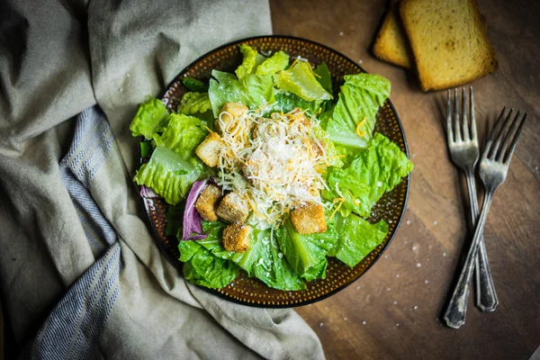 Salada Caesar em fundo rústico — Fotografia de Stock