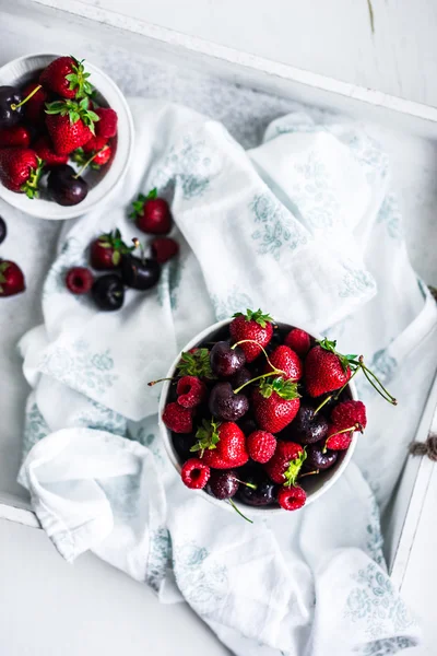 Mix of berries on white rustic background — Stock Photo, Image