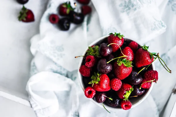 Mix of berries on white rustic background — Stock Photo, Image