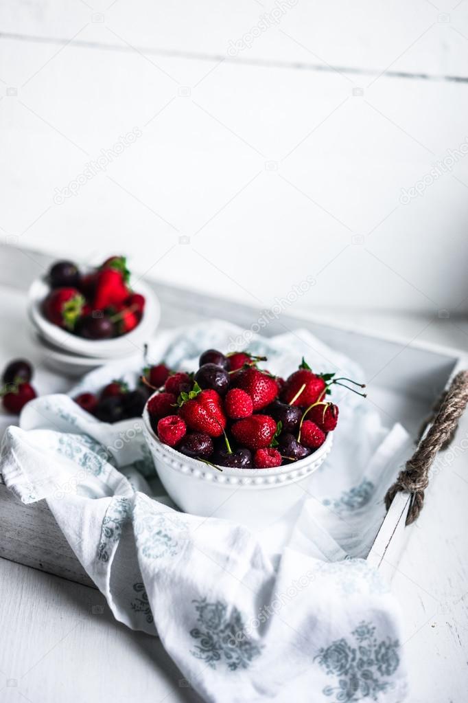 Mix of berries on white rustic background