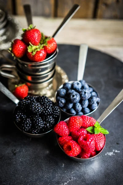 Mix of fresh berries on rustic background — Stock Photo, Image