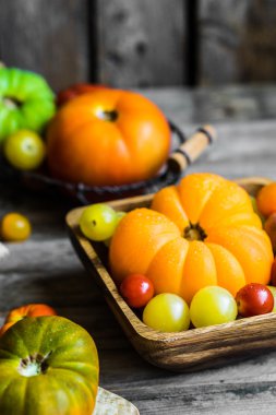 Rustik ahşap arka plan üzerinde renkli hatıra domates