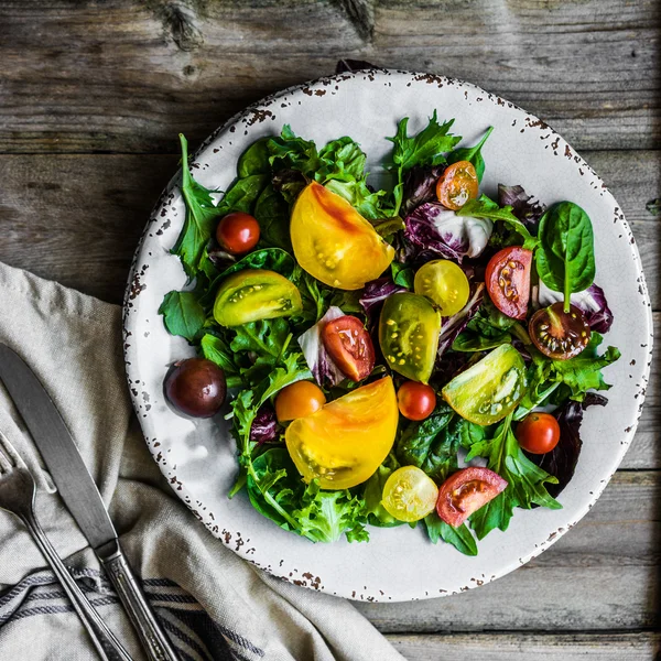 Salada fresca com espinafre, arugula e tomate de herança em rústico — Fotografia de Stock