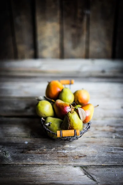 Autumn pears on rustic wooden background — Stock Photo, Image
