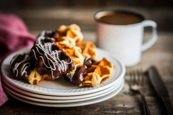 Belgian waffles with chocolate on rustic wooden background — Stock Photo, Image