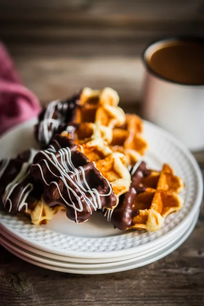 Belgian waffles with chocolate on rustic wooden background — Stock Photo, Image