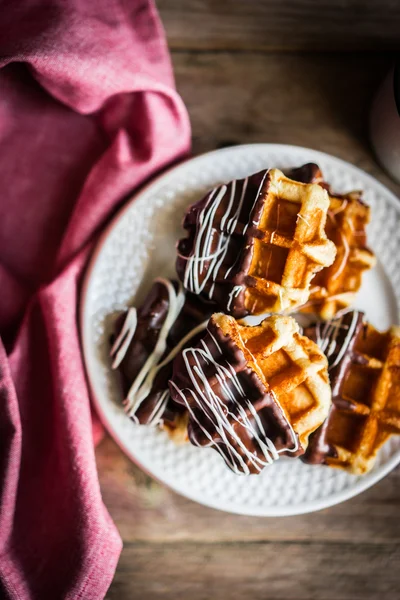 Belgian waffles with chocolate on rustic wooden background — Stock Photo, Image