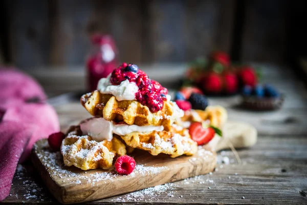 Belgian waffles with fresh berries on rustic wooden background — Stock Photo, Image