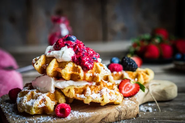 Belgian waffles with fresh berries on rustic wooden background — Stock Photo, Image