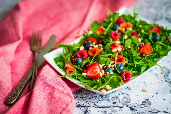 Zdravý salát s rukolou, špenátem, uzeným lososem a bobule — Stock fotografie