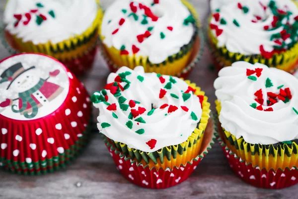 Christmas cupcakes on wooden background — Stock Photo, Image