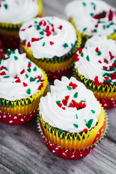 Christmas cupcakes on wooden background — Stock Photo, Image