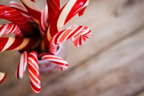 Christmas candy canes on wooden background — Stock Photo, Image