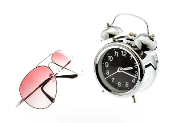 Sunglasses with alarm clock isolated on white — Stock Photo, Image