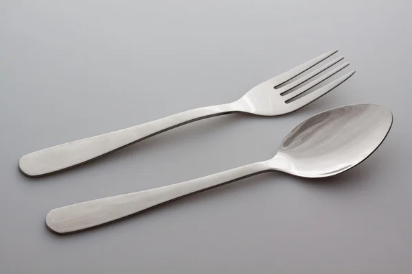 A silver fork with spoon isolated on gray background — Stock Photo, Image