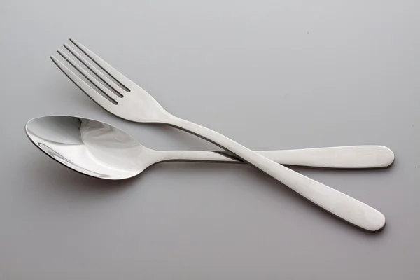 A silver fork with spoon isolated on gray background Stock Picture