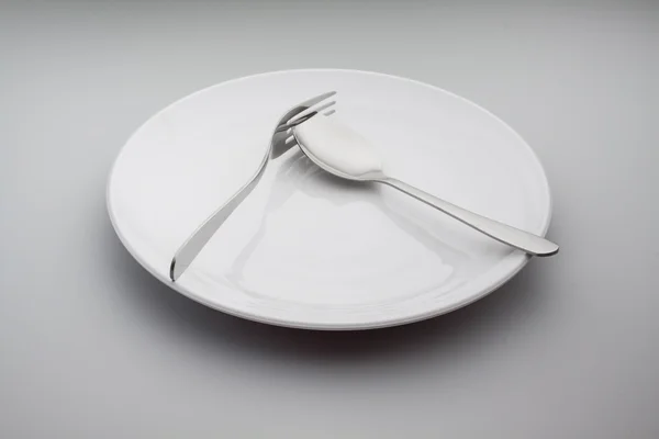 Placas con tenedor de plata y cuchara aisladas sobre fondo gris — Foto de Stock