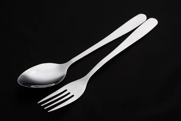 A silver fork with spoon isolated on black background — Stock Photo, Image