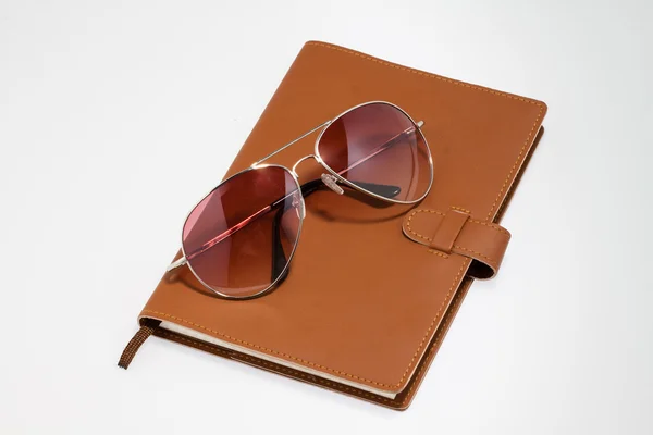 Notebook with sunglasses — Stock Photo, Image