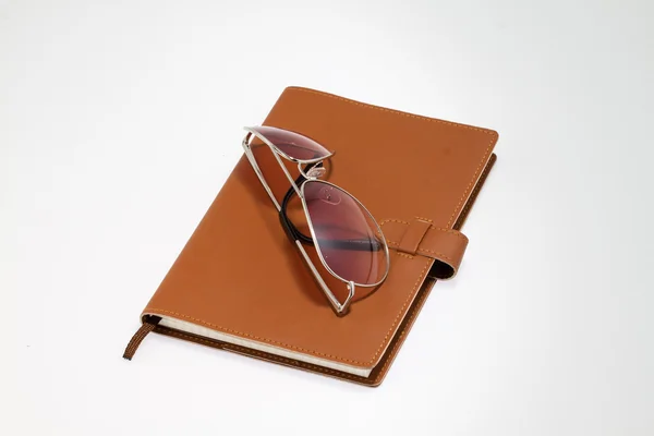 Notebook with sunglasses — Stock Photo, Image