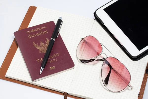 Comprimido com passaporte notebook e caneta — Fotografia de Stock