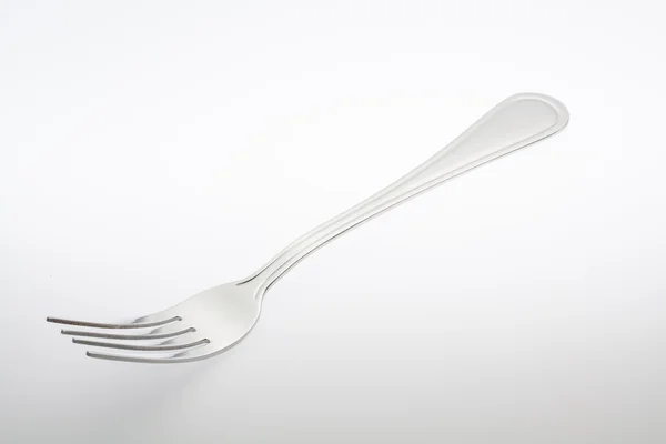Een zilveren vork, geïsoleerd op grijze achtergrond — Stockfoto
