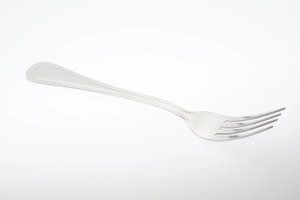 Een zilveren vork, geïsoleerd op grijze achtergrond — Stockfoto
