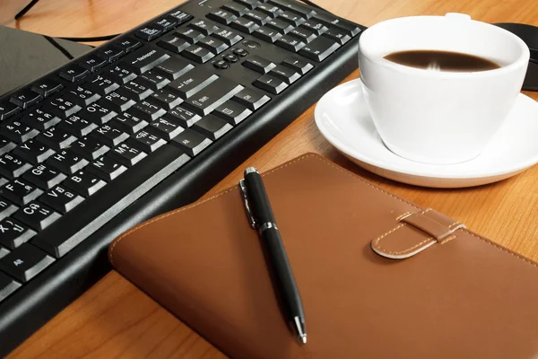 Office desk with coffee cup — Stock Photo, Image