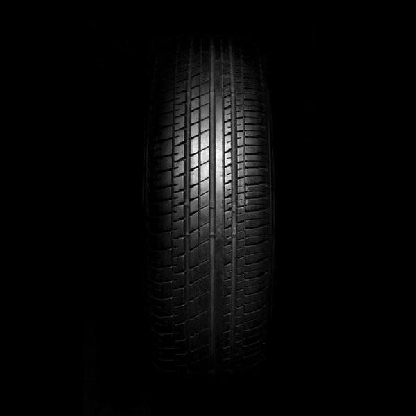 Car tires close-up on black background