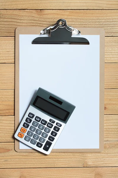 Clip board with calculator on wood background — Stock Photo, Image