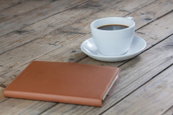 White cup of coffee on wood — Stock Photo, Image