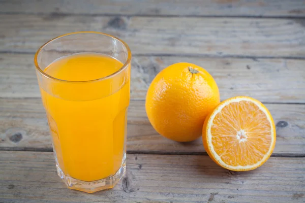 Закрытый апельсиновый сок на деревянном фоне — стоковое фото