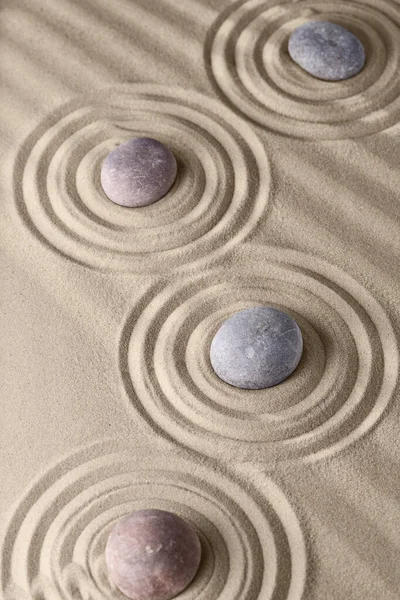 Circles on the sand and round stones in the rock garden, for relaxation and spiritual harmony. Zen garden of meditation, relaxation, restoration of balance and harmony of spirituality, relaxation