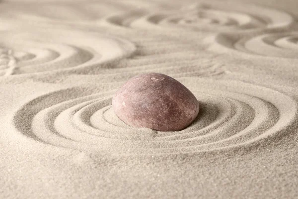 Circles on the sand and round stones in the rock garden, for relaxation and spiritual harmony. Zen garden of meditation, relaxation, restoration of balance and harmony of spirituality, relaxation