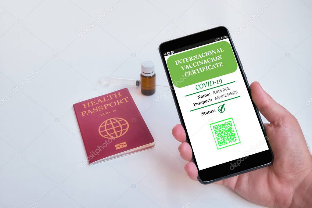 Smartphone with valid digital vaccination certificate COVID-19.Inmunity passport, health and surveillance concepts. Fake