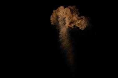 Kumsal patlaması siyah arka planda izole edildi. Soyut kum bulutu.