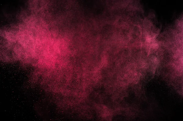 Magenta powder explosion on black background. — Stock Photo, Image