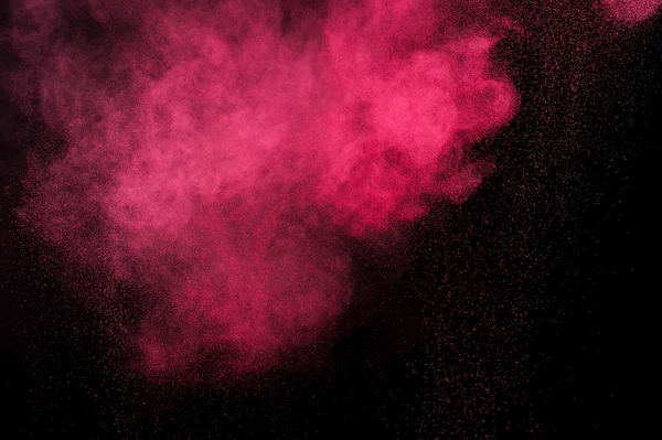 Explosión de polvo magenta sobre fondo negro . — Foto de Stock