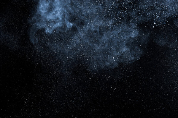 Abstract white powder explosion on black background