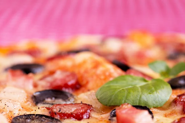 Homemade pizza with hunter sausages, bacon, olives and basil — Stock Photo, Image