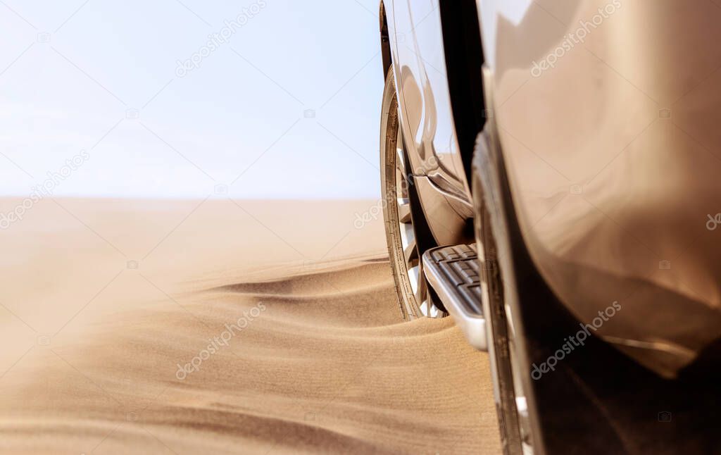 Close up of a golden car stuck in the sand in the Namib desert. Africa