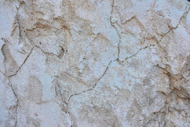 Yüksek çözünürlüklü bej alçı duvar dokusu, doğal çatlaklar ve yıpranmış yüzey. Geleneksel Arap ve Orta Doğu mimarisinden esinlenilmiştir.