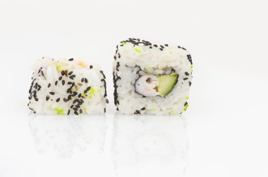 Karides ile avokado California rulo ve salatalık karanlık tohumu, beyaz arka planda haddelenmiş
