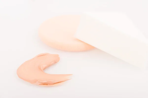 Liquid tinted make-up cream foundation sample stroke and sponges — Stock Photo, Image