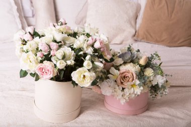 Yataktaki hediye kutusunda bir buket narin gül..