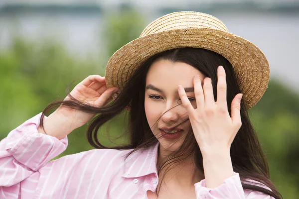 Girl Straw Boater Hat Straightens Hair Her Hand Windy Weather — Zdjęcie stockowe