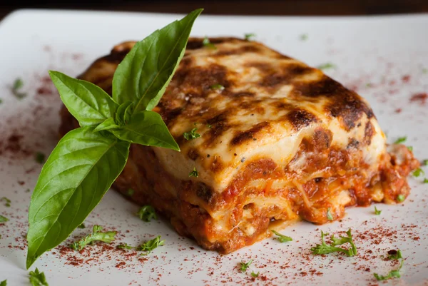 Lasagna on a square white plate — Stock Photo, Image